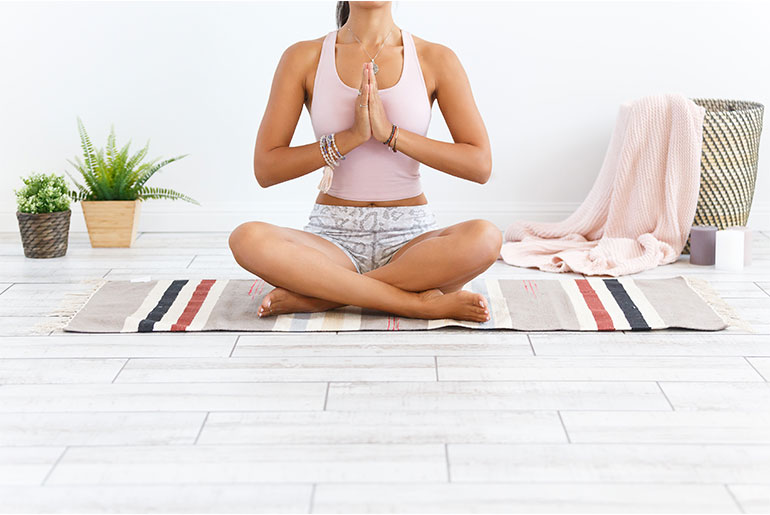 Kvinde, der dyrker yoga og mediterer